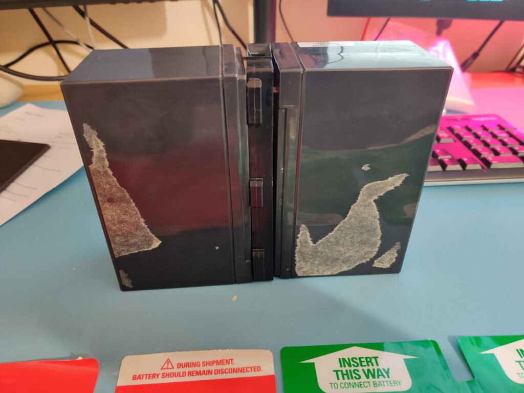 The two black cells side by side, adhesive residue where the plates were