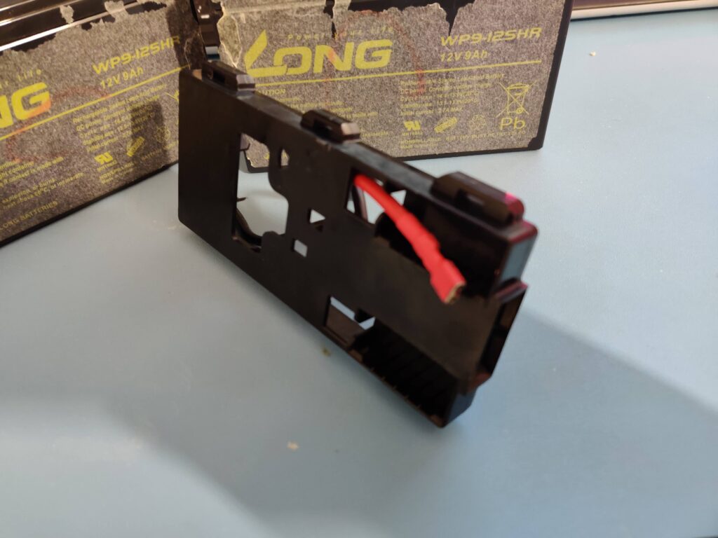 The holder alone, the red lead running the length of it