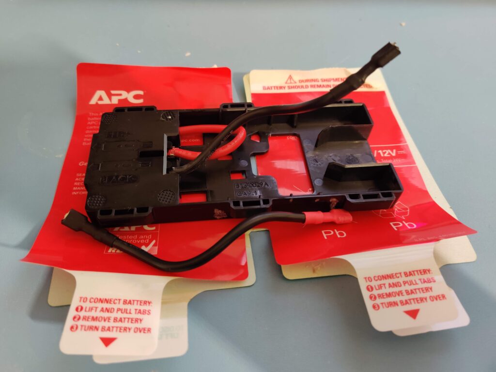 The holder and its two leads resting on the peeled APC sticker plates